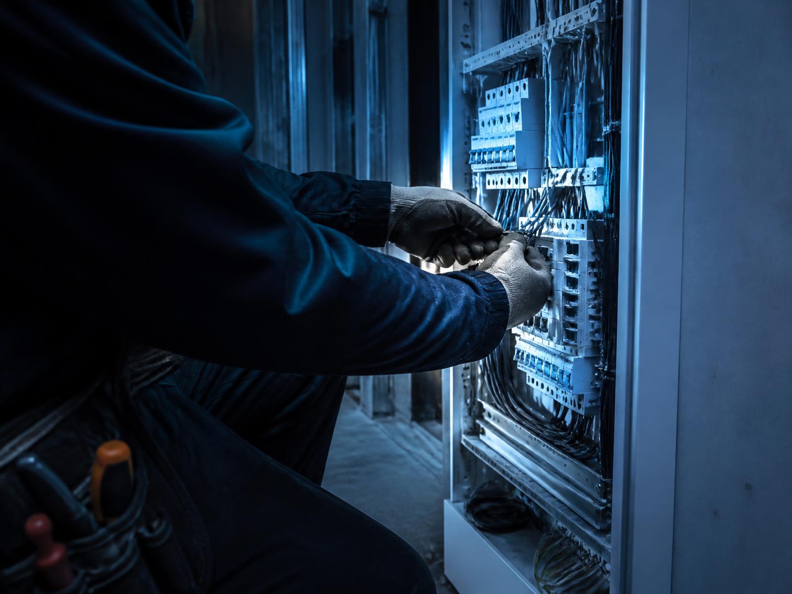 Electrician wiring a modern electrical panel on a jobsite
